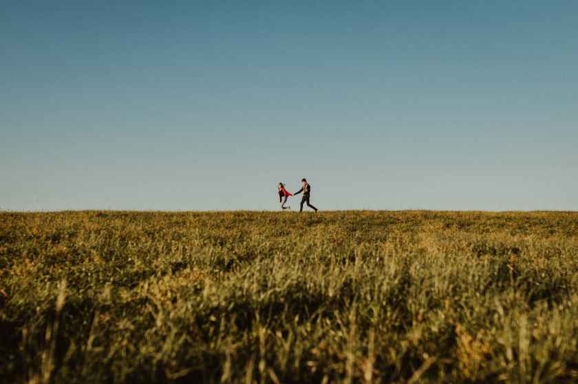 couple running happily in field